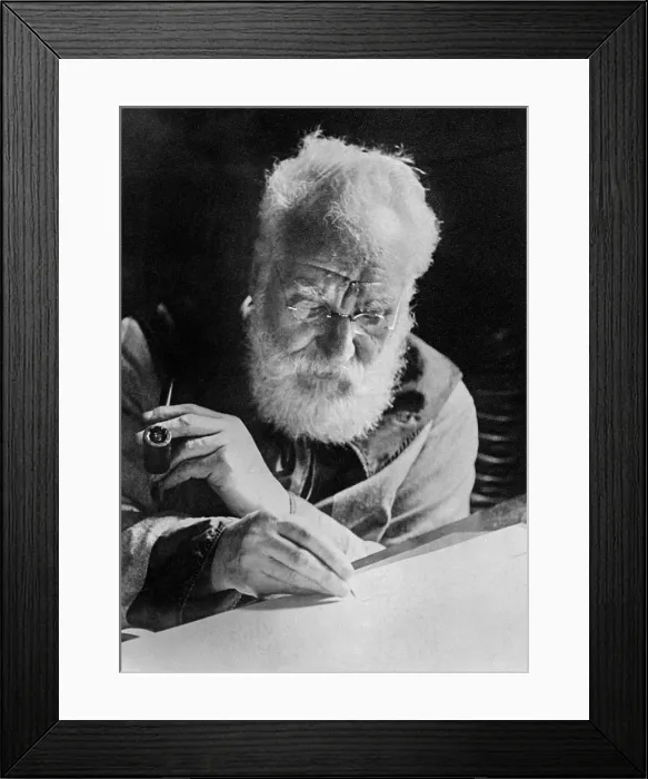 Framed Print : Alexander Graham Bell (1847-1922), writing at his desk in his study in Washington. 1913