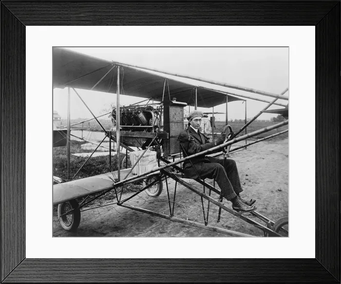 Framed Print : Glenn Martin (1886-1955), delivering newspapers in his airplane. He built his first airplane in 1909, and his first airplane factory in 1912 in Los Angeles, California