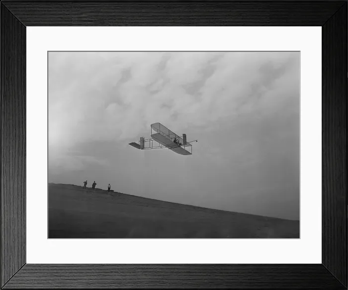 Framed Print : Wilbur Wright pilots a glider during Wright Brothers flight experiments at Kitty Hawk, North Carolina. Ca. 1902