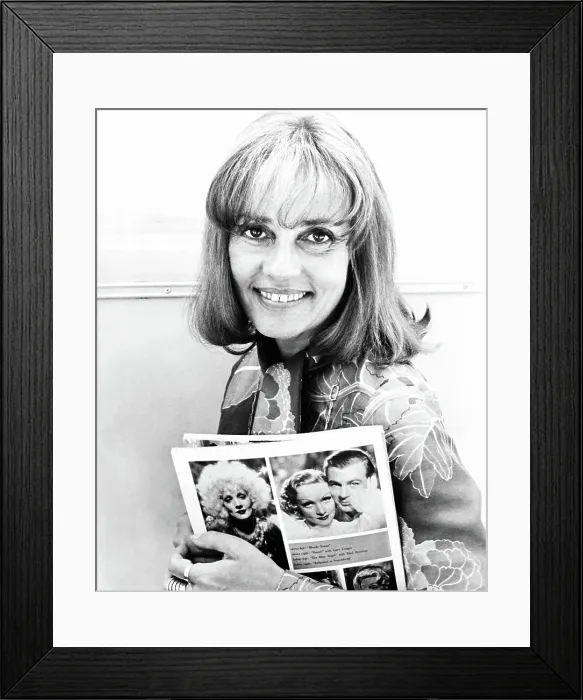 Framed Print : ALEX IN WONDERLAND, Jeanne Moreau (holding photos of Marlene Dietrich and Gary Cooper in BLONDE VENUS and DESIRE), 1970