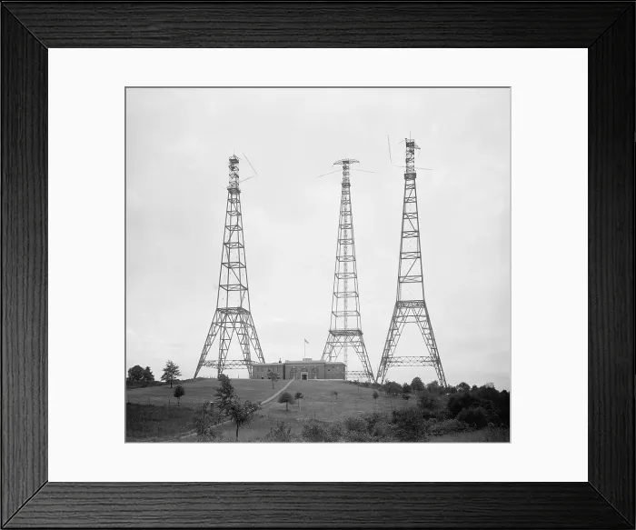 Framed Print : Dwarfing the substantial building beneath them, these radio broadcasting towers were new to the American landscape when this photo was taken in the Washington D.C
