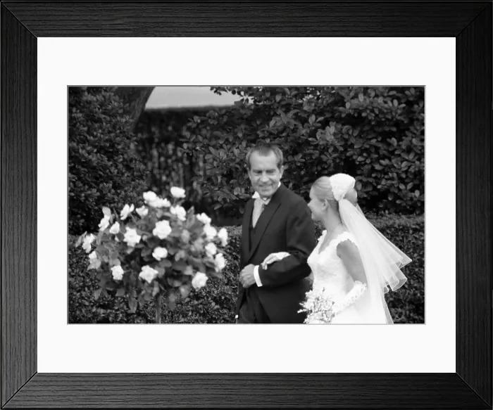 Framed Print : President Richard Nixon escorting daughter Tricia Nixon at her wedding at the White House. Tricia dress was designed by Priscilla of Boston. June 12 1971