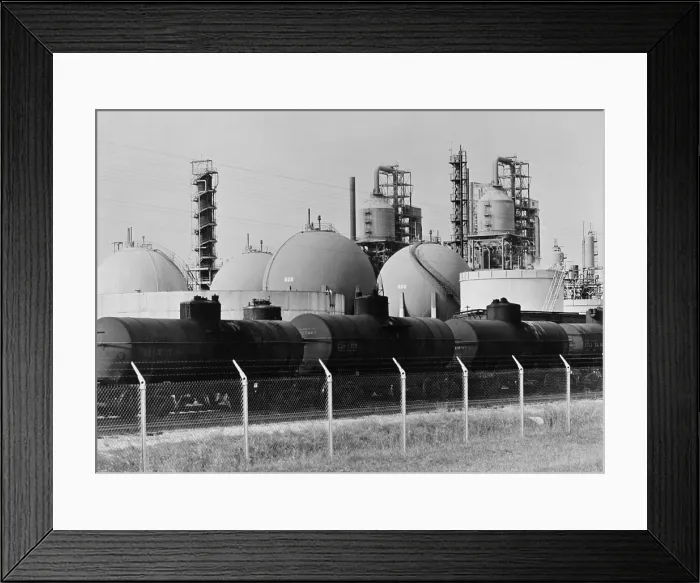 Framed Print : Railroad tank cars at an United States oil refinery to receive gasoline stored in large spherical tanks. Ca. 1944