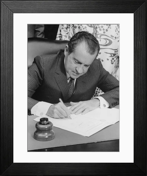 Framed Print : Richard Nixon signing a bill into law. Ca. 1969-74