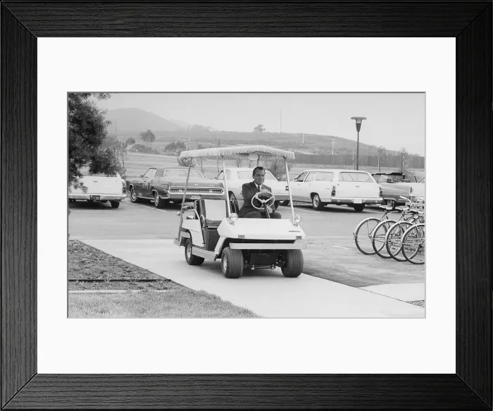 Framed Print : Richard Nixon driving a golf cart in a sidewalk to the helipad at San Clemente. Ca. 1969-74 Framed Print : Richard Nixon driving a golf cart in a sidewalk to the helipad at San Clemente. Ca. 1969-74