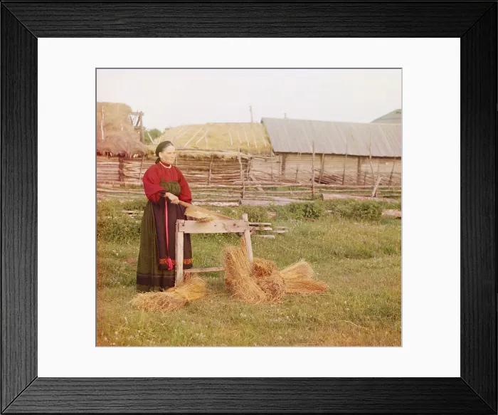 Framed Print : Russian peasant woman braking dried flax in a scutcher, to remove the flax's woody outer lay, leaving only the fibers. 1910 special process color photo Sergei Prokudin-Gorskii