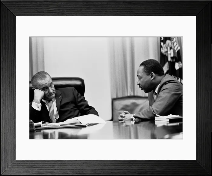 Framed Print : Lyndon Johnson listening to Martin Luther King during a meeting with civil rights leaders at the White House. March 18, 1966