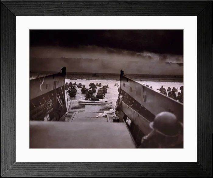 Framed Print : American soldiers wade from Coast Guard landing craft toward the Omaha Beach against machine gun fire on D-Day. June 6, 1944, by Coast Guard photographer, Robert F. Sargent