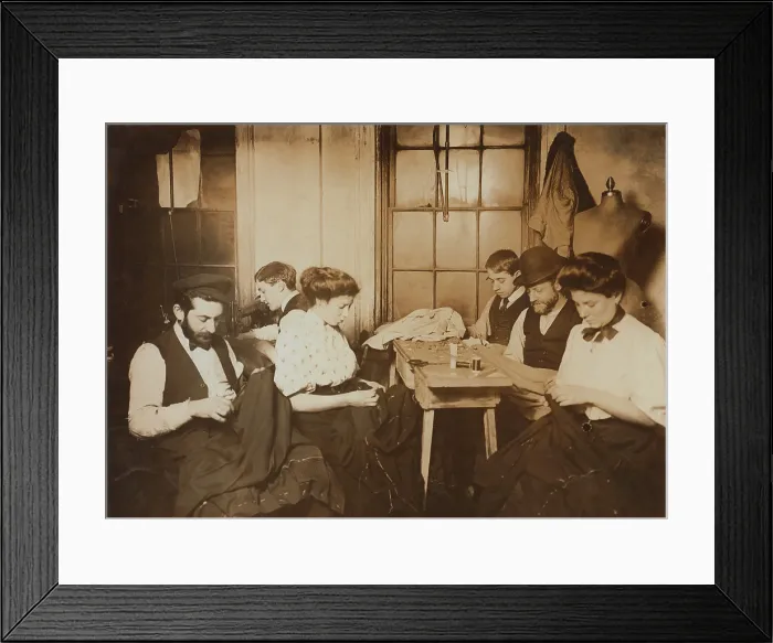 Framed Print : Garment workers sewing by hand in a small New York City sweatshop in1908. Photo by Lewis Hine