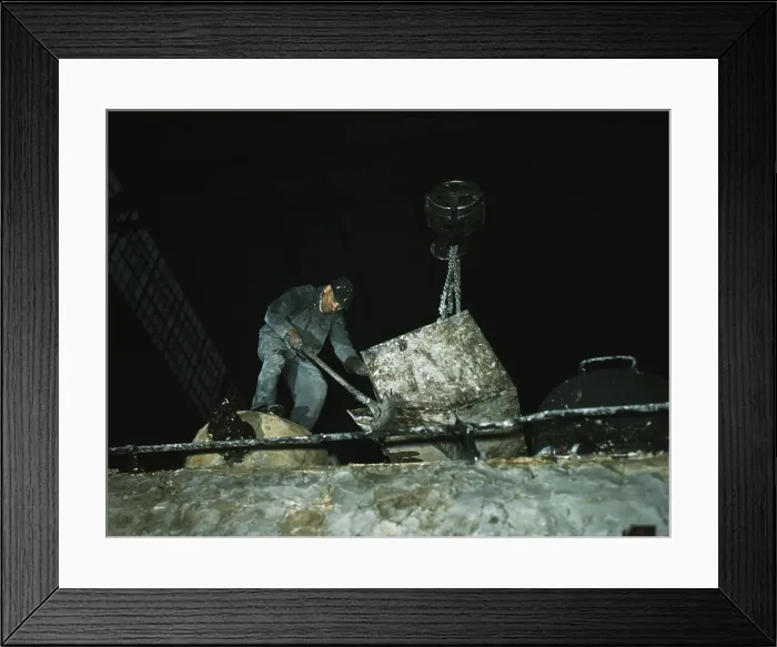Framed Print : Worker spreading a hazardous asbestos mixture on boiler of a locomotive at a NYC railroad shops in December 1942