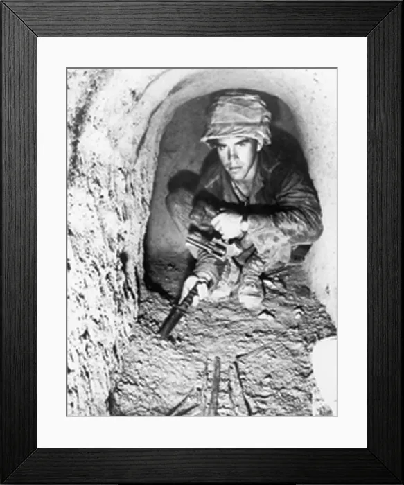 Framed Print : American soldier using a knife to probe the floor of a Viet Cong tunnel in the Iron Triangle north of Saigon, South Vietnam. Jan. 1967