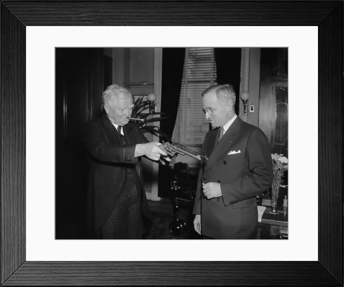Framed Print : VP James Garner handles 45-caliber pistols as Sen. Harry Truman watches. Feb.17, 1938