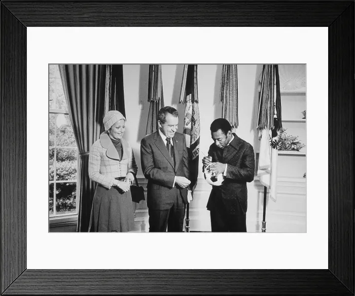 Framed Print : Pele signs a soccer ball for President Nixon as his wife Rosemeri watches. At the time Pele Director of the International Soccer Program sponsored by PepsiCo. May 8 1973