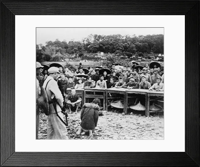 Framed Print : Chinese farmer, kneeling at gunpoint before a court enforcing communist land reforms in July 1952