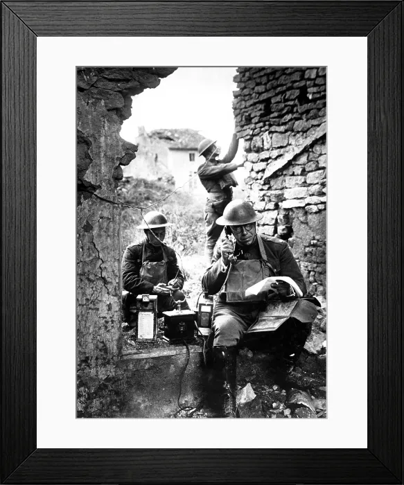 Framed Print : American signal officer of the 42nd Division, testing a telephone left behind by retreating Germans in the St. Mihiel salient. Essey, France. World War I. Sept. 19, 1918