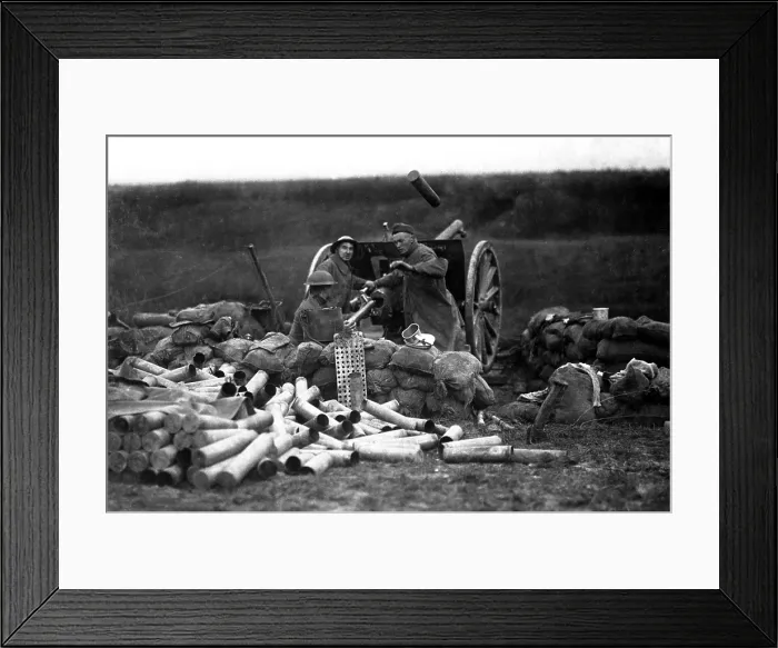 Framed Print : American Field Artillery on the Lorraine front in Beaumont, France. An ejected shell case flies through the air as a new shell is put into the breech in the same a second