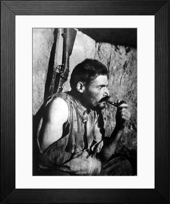 Framed Print : French World War I soldier smoking a pipe and resting after battle. 1914-1918 Framed Print : French World War I soldier smoking a pipe and resting after battle. 1914-1918