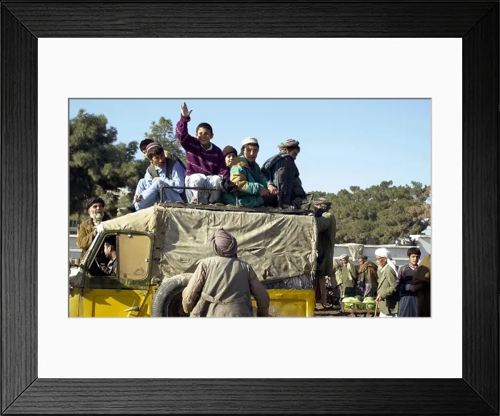 Framed Print : Local Afghanis ride a crowded taxi in Mazar-e Sharif a month after the Taliban were driven from their city by Northern Alliance troops under General Dostum's command. Dec
