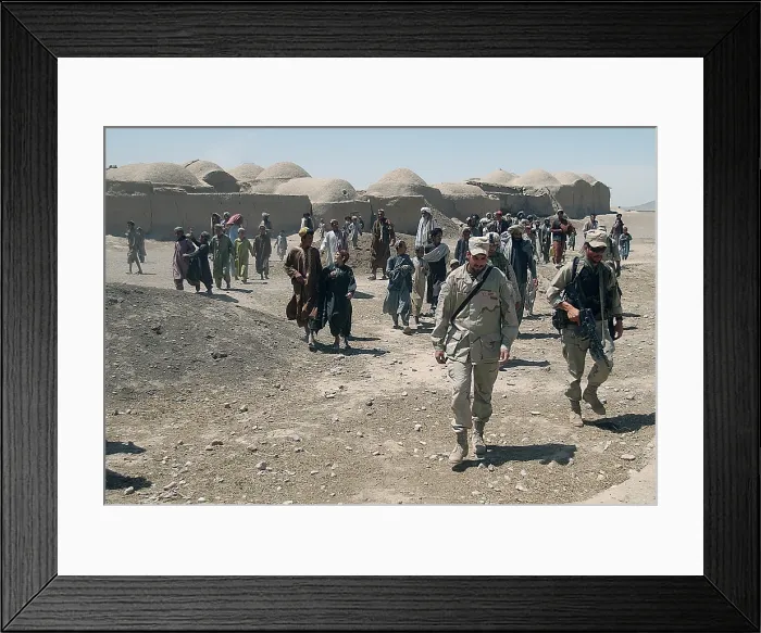 Framed Print : Villagers from Nojoy outside Kandahar International Airport follow the members of the U.S