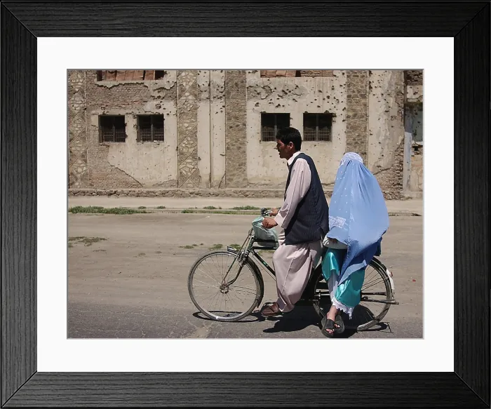 Framed Print : An Afghani couple rides a bicycle through the streets of Kabul Afghanistan after the Taliban were ousted. May 10 2002. Photo by:Everett Collection(BSLOC_2011_6_92)