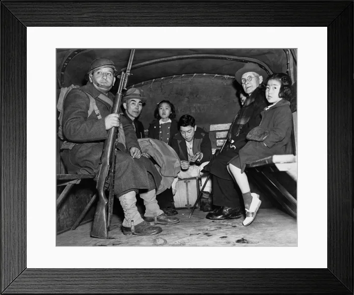 Framed Print : Under armed guard, parentless children and a pastor sit in the back of truck for their evacuation from Bainbridge Island, during the World War II internment of Japanese Americans Framed Print : Under armed guard, parentless children and a pastor sit in the back of truck for their evacuation from Bainbridge Island, during the World War II internment of Japanese Americans