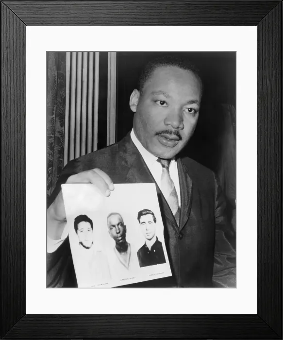 Framed Print : Dr. Martin Luther King (1929-1968), holding photographs of three civil rights workers who were murdered by the Ku Klux Klan: Andrew Goodman, James Earl Chaney