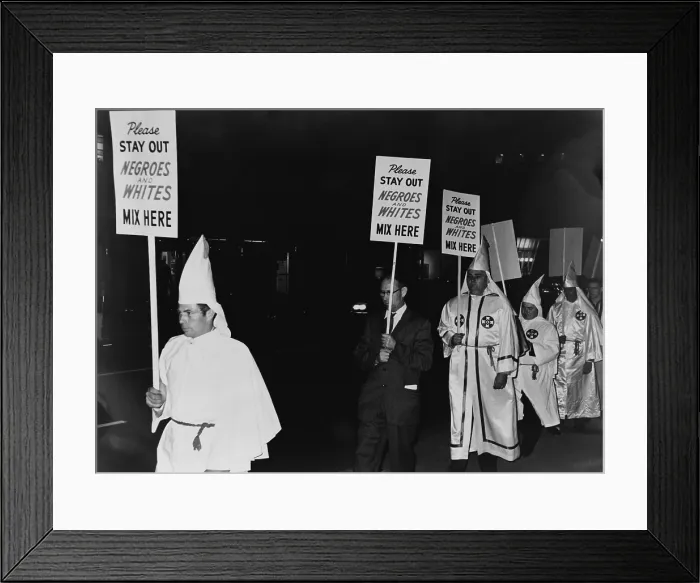 Framed Print : Ku Klux Klan members, in hooded white robes hoods, picket an integrated business carrying placards stating, Please stay out, Negroes and Whites mix here'. 1964 Framed Print : Ku Klux Klan members, in hooded white robes hoods, picket an integrated business carrying placards stating, Please stay out, Negroes and Whites mix here'. 1964