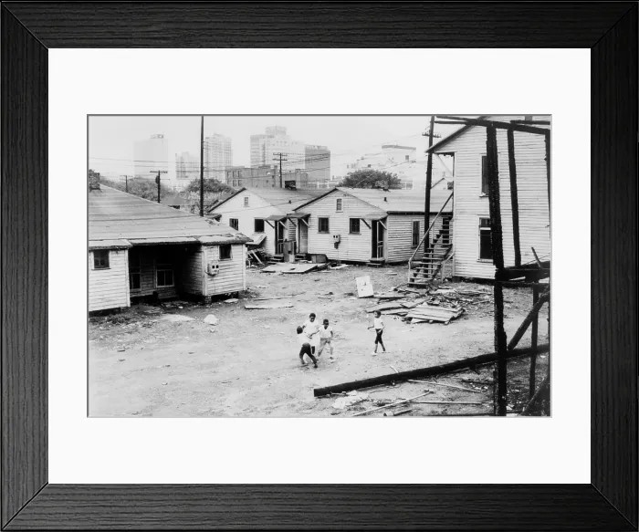 Framed Print : African American children playing in slum in view of high rise buildings in background. North Carolina, ca. 1966 Framed Print : African American children playing in slum in view of high rise buildings in background. North Carolina, ca. 1966