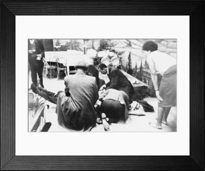Framed Print : Followers of Malcolm X kneel by the mortally wounded Black Muslim leader on February 21, 1965