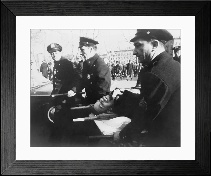 Framed Print : Malcolm X (1925-1965), on stretcher carried by New York policemen following his assassination at rally in a Harlem. February 21, 1965