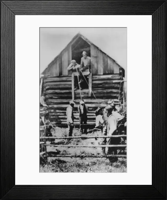 Framed Print : Photographic postcard of a few men preparing to lynch African American man by hanging from a barn