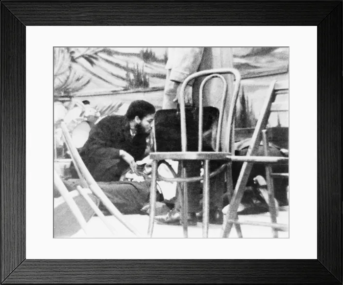 Framed Print : Followers of Malcolm X kneel by the dying Black Muslim leader on February 21, 1965, in Harlem's Audubon Ballroom. He was hit by sixteen bullets fired by three assassins