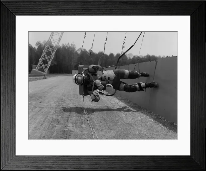 Framed Print : Astronaut training for Moon missions. Subject wears a pressurized space suit and is suspended for reduced gravity walking simulation Framed Print : Astronaut training for Moon missions. Subject wears a pressurized space suit and is suspended for reduced gravity walking simulation