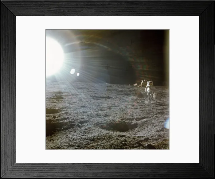 Framed Print : Apollo 12 Astronaut Alan Bean deploys scientific experiments on the lunar surface. The bright flare of light is caused by the Sun. The Lunar Lander is in the distance. Nov