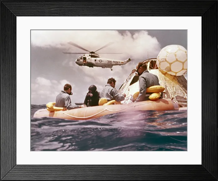 Framed Print : Apollo 12 Pacific recovery. Astronauts are in a life raft near the Command module with a Helicopter hovering above. Nov. 24, 1969