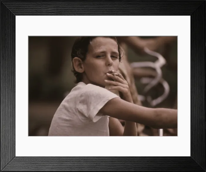 Framed Print : A pre-teen boy smoking a cigarette on Kansas City's west side. Ca. 1973-75 Framed Print : A pre-teen boy smoking a cigarette on Kansas City's west side. Ca. 1973-75