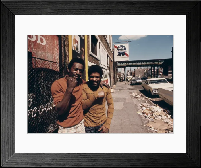 Framed Print : Smiling African American men on a garbage strewn street on the South Side of Chicago. Ca. 1975