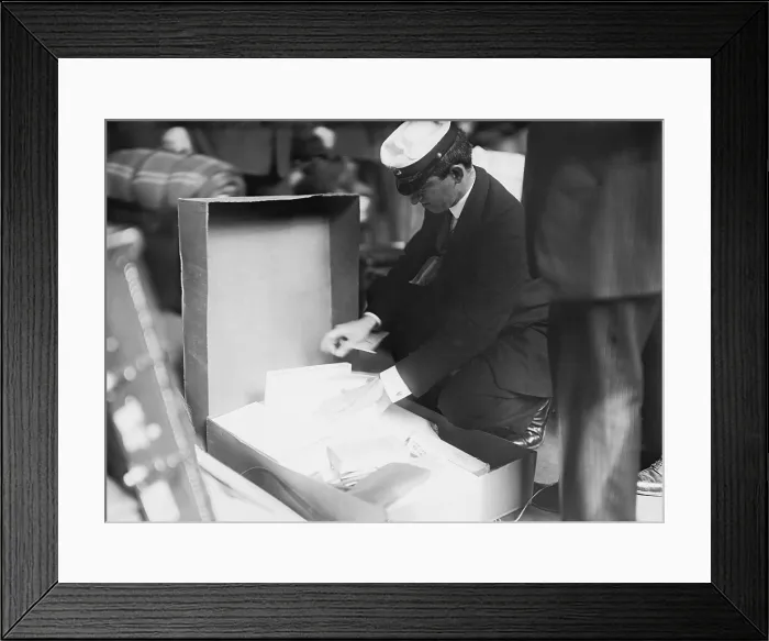 Framed Print : Customs officer inspecting luggage of a passenger at the Norddeutscher Lloyd pier in New York City. Ca. 1909 LC-DIG-ggbain-04210