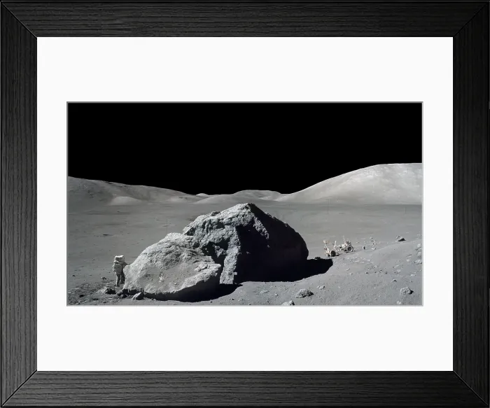Framed Print : Apollo 17 Geologist-Astronaut Harrison Schmitt standing next to a huge, split lunar boulder. Schmitt and Eugene Cernan travel to this site in the Lunar Rover (at right). Nov