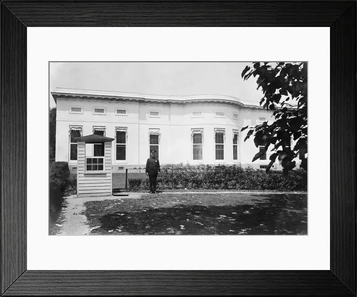 Framed Print : Police box and guard in the rear of the West Wing of the White House. At center left are the three windows of the Oval Office built into the 1902 structure by President William H