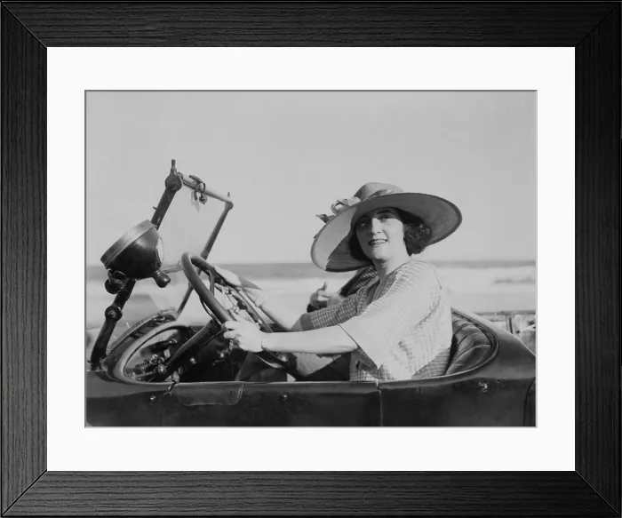 Framed Print : Young woman at steering wheel of automobile. 1921. LC-USZ62-100382