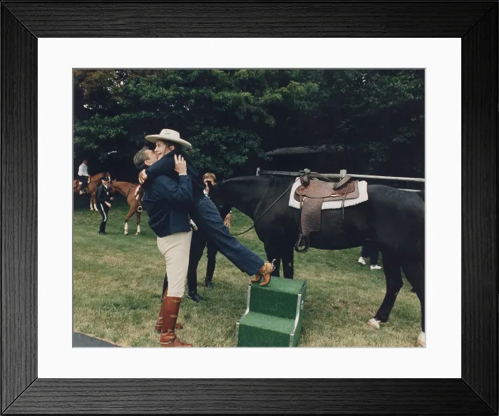 Framed Print : Ronald Reagan affectionately assists First Lady Nancy Reagan during horseback riding at the Maryland Presidential retreat Camp David. July 21 1984. (BSLOC_2011_2_26)