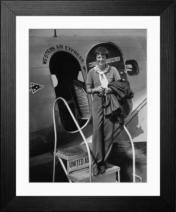 Framed Print : Amelia Earhart 1897-1937 standing in the door of a Western Airlines planes in California as she embarks to New York to make her first New York first public appearance at Carnegie