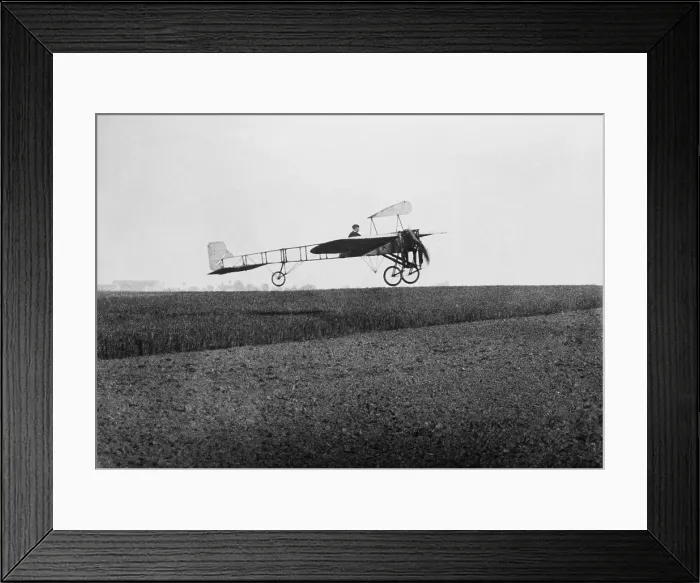 Framed Print : Louis Bleriot 1872-1936 in flight over a field on May 5 1909 probably during practice runs for his July 25 1909 37 minute historic first flight across the English Channel from Les