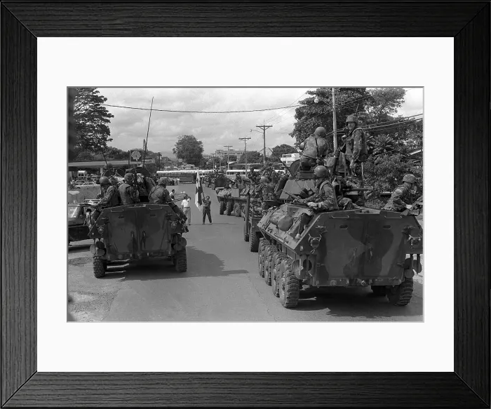 Framed Print : A flag-waving supporter of Manuel Noriega halts a column of U.S. Marines on patrol in light armored vehicles outside the city of La Chorrera Panama