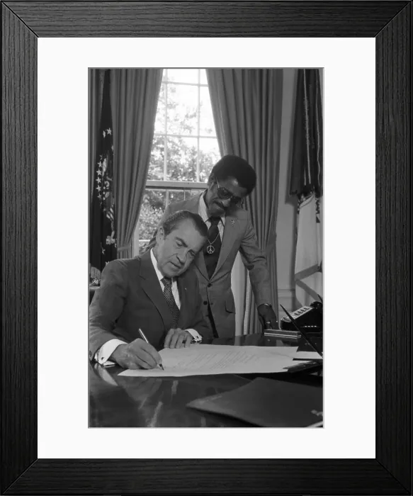 Framed Print : President Nixon and Sammy Davis. Nixon signs a document appointing Davis to the National Advisory Council on Economic Opportunity. July 1 1971
