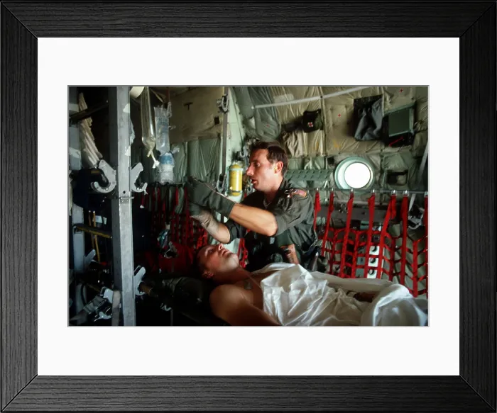 Framed Print : A medic adjusts the intravenous drip bag of a wounded US serviceman en route to a medical facility after the invasion of Grenada. He was one of the 134 U.S Framed Print : A medic adjusts the intravenous drip bag of a wounded US serviceman en route to a medical facility after the invasion of Grenada. He was one of the 134 U.S