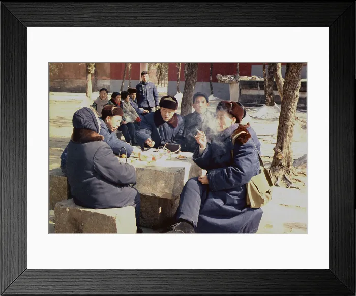Framed Print : Chinese people in coats and warm hats have lunch outdoors in Beijing during Nixon's visit to China. Feb. 21-27 1972