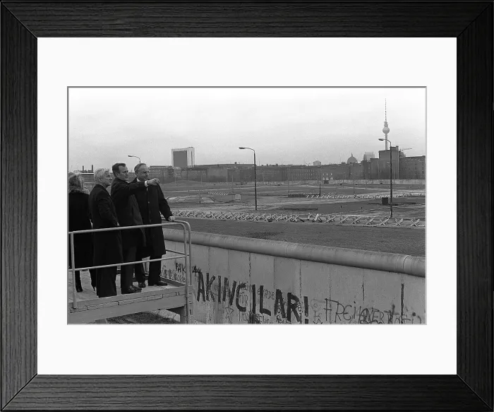 Framed Print : Vice President George Bush looks over the Berlin Wall into East Berlin. He is escorted by Mayor Von Weizacker and Chancellor Kohl on Bush's left. Feb. 1 1983