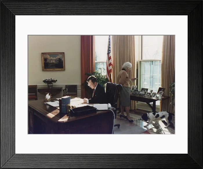 Framed Print : During his first week as president George Bush works in the Oval Office as wife Barbara looks at photographs behind the his desk. Jan. 27 1989. (BSLOC_2011_3_91) Framed Print : During his first week as president George Bush works in the Oval Office as wife Barbara looks at photographs behind the his desk. Jan. 27 1989. (BSLOC_2011_3_91)